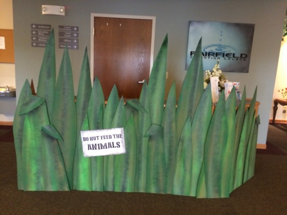 Turned our information counter into this cool area of tall grass with an animal warning.