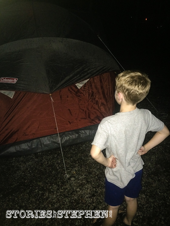 Will is examining the tent after the latest downpour, wondering if it is dry inside where he is about to sleep.