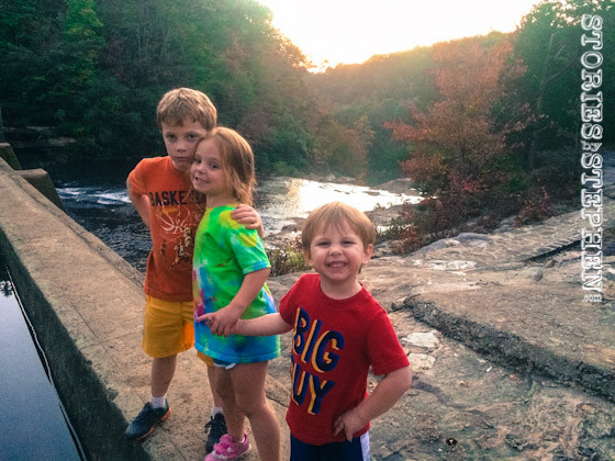 The kids standing on the dam.