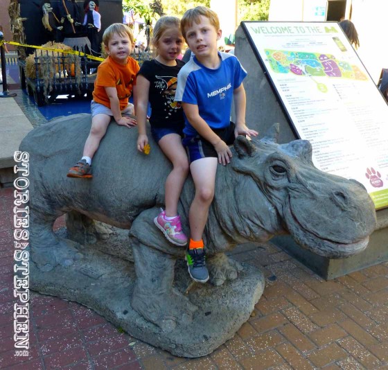 My kids riding the hippo statue.