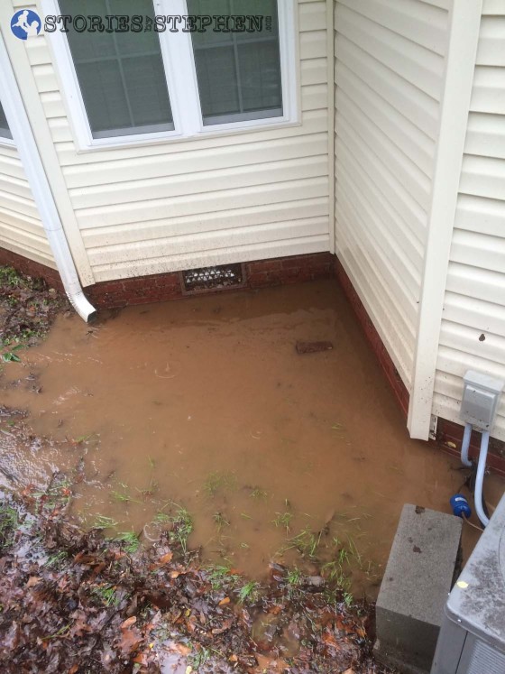 The water kept pooling up in this little nook on the back of the house. It would not flow around the side of the house, so I had to create 2 water hose syphons to pull water out and keep it from getting too deep on the back of the house.